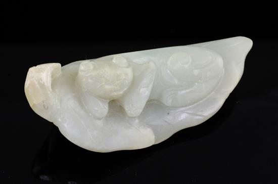 A Chinese celadon jade carving of a recumbent cat on a leaf, 18th / 19th century,